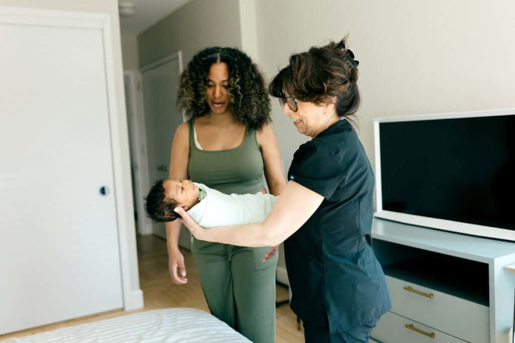 Newborn Care Specialist with baby and new mom