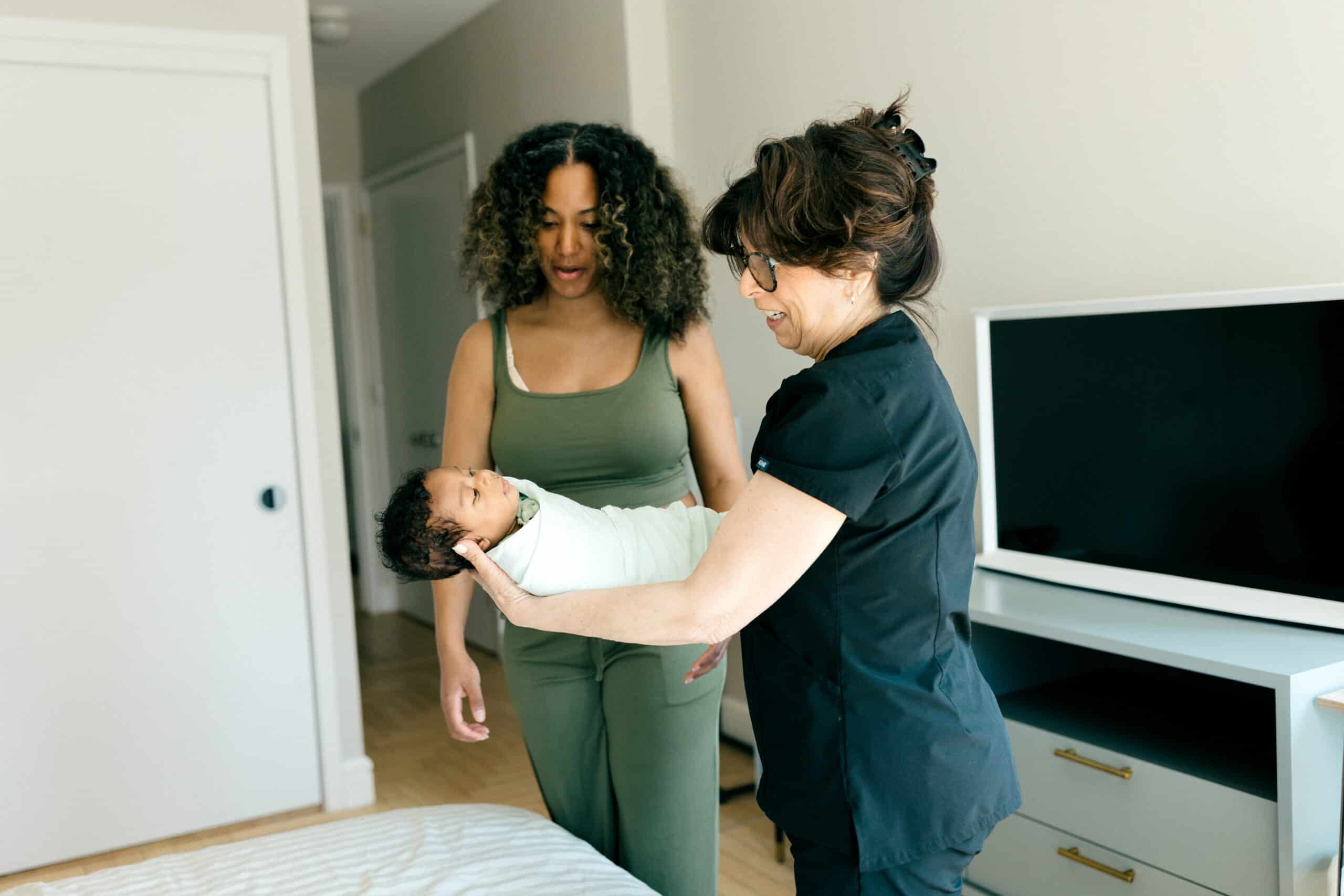 Newborn Care Specialist with baby and new mom