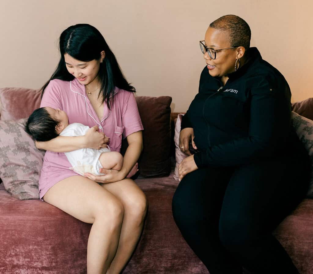 Postpartum Doula supporting new mother and her newborn
